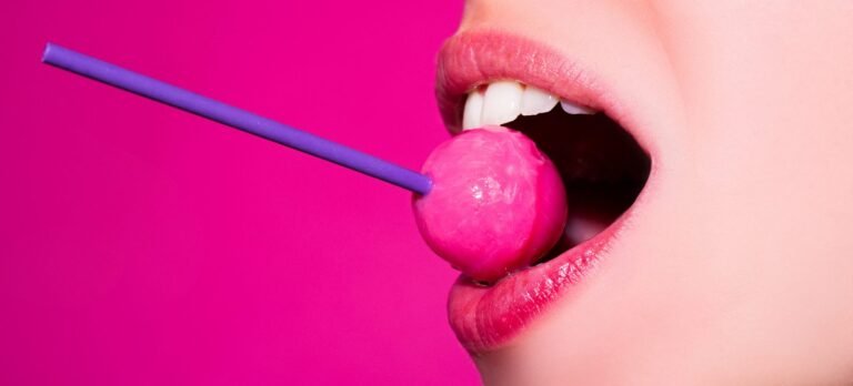 licking-candy-lollipop-model-woman-lips-sucking-candy-glamor-sensual-model-with-red-lips-eat-sweats-lolly-pop-isolated-pink-1-scaled-1